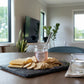 Within You Farm lavender jelly with a spoon, served with cheese and crackers on a slate board