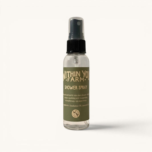 Within You Farm shower spray with eucalyptus and lavender essential oils for a soothing aromatherapy experience. Clear bottle with green label.