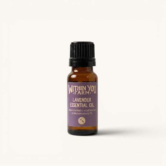 Within You Farm lavender essential oil in a 15ml amber glass bottle with a black cap. The label is purple with white text.